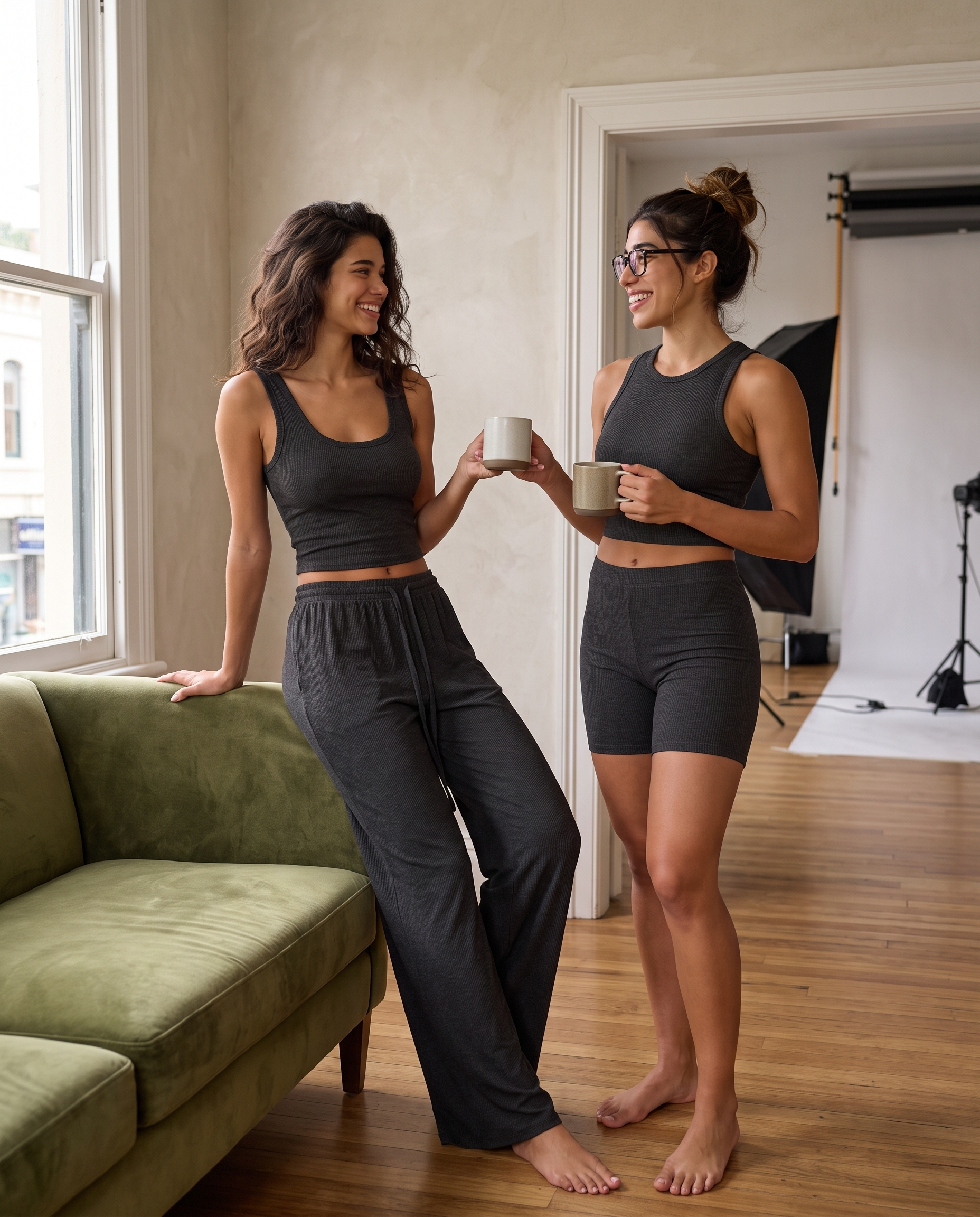 Two models wearing the charcoal black Ribbed Lounge set, showing the drawstring details