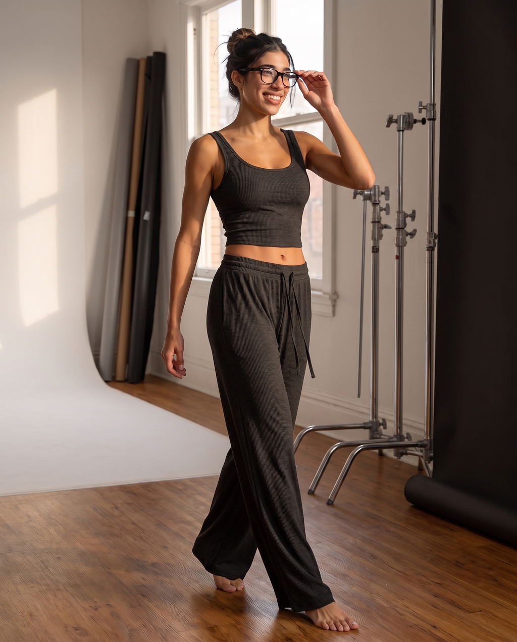 Model wearing the Ribbed Lounge Wide-Leg Pants in charcoal black, showing the drawstring waist