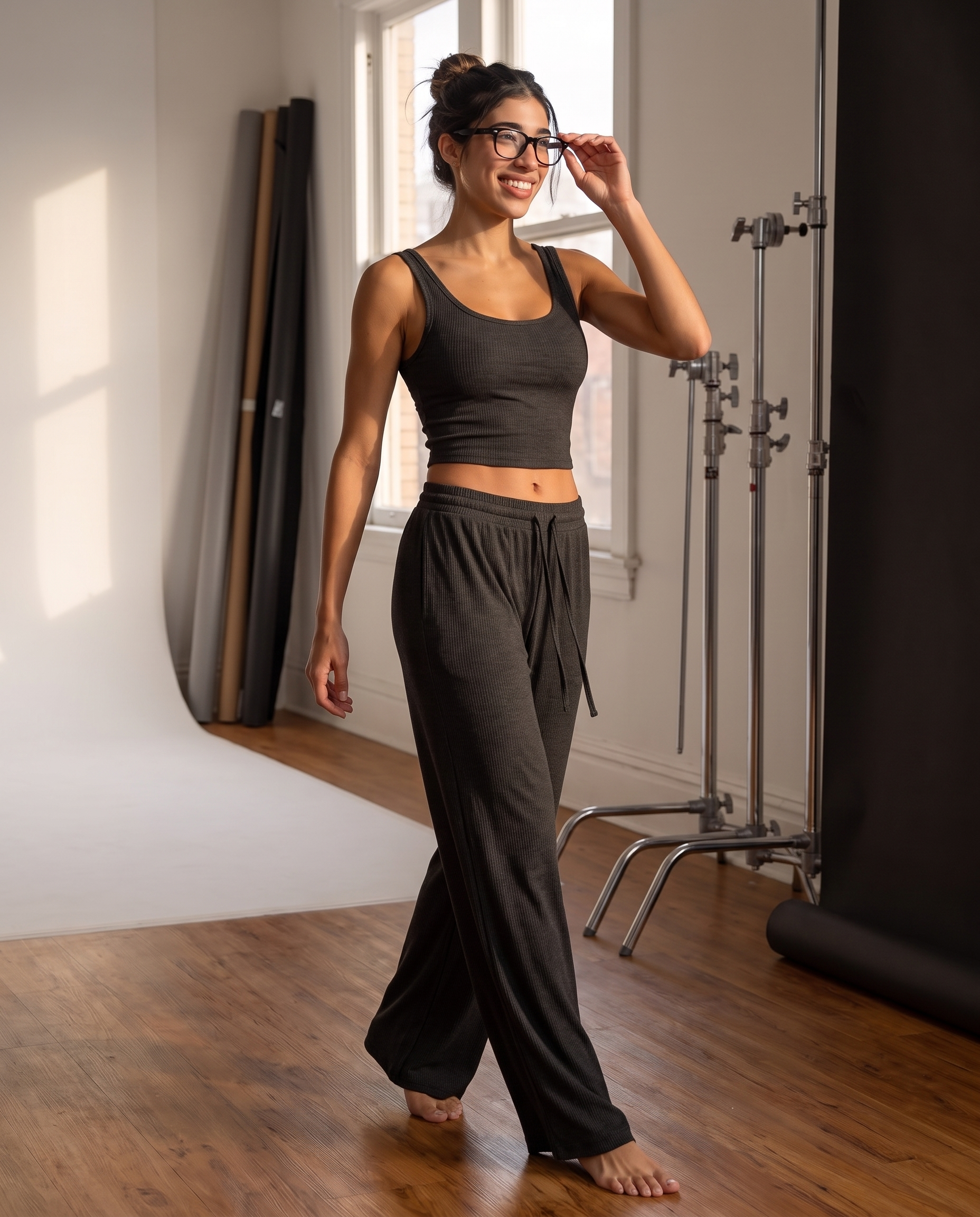 Model wearing the Ribbed Lounge Wide-Leg Pants in charcoal black, showing the drawstring waist