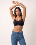 Model with arms overhead in the Everyday Wireless Bra in black