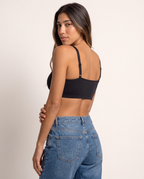 Model looking over her shoulder, showing the back of the Wireless Shaping Bra in black