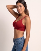 Model in a side pose with hand behind head, wearing the Everyday Wireless Bra in red