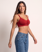 Model in a playful turn wearing the Wireless Shaping Bra in red