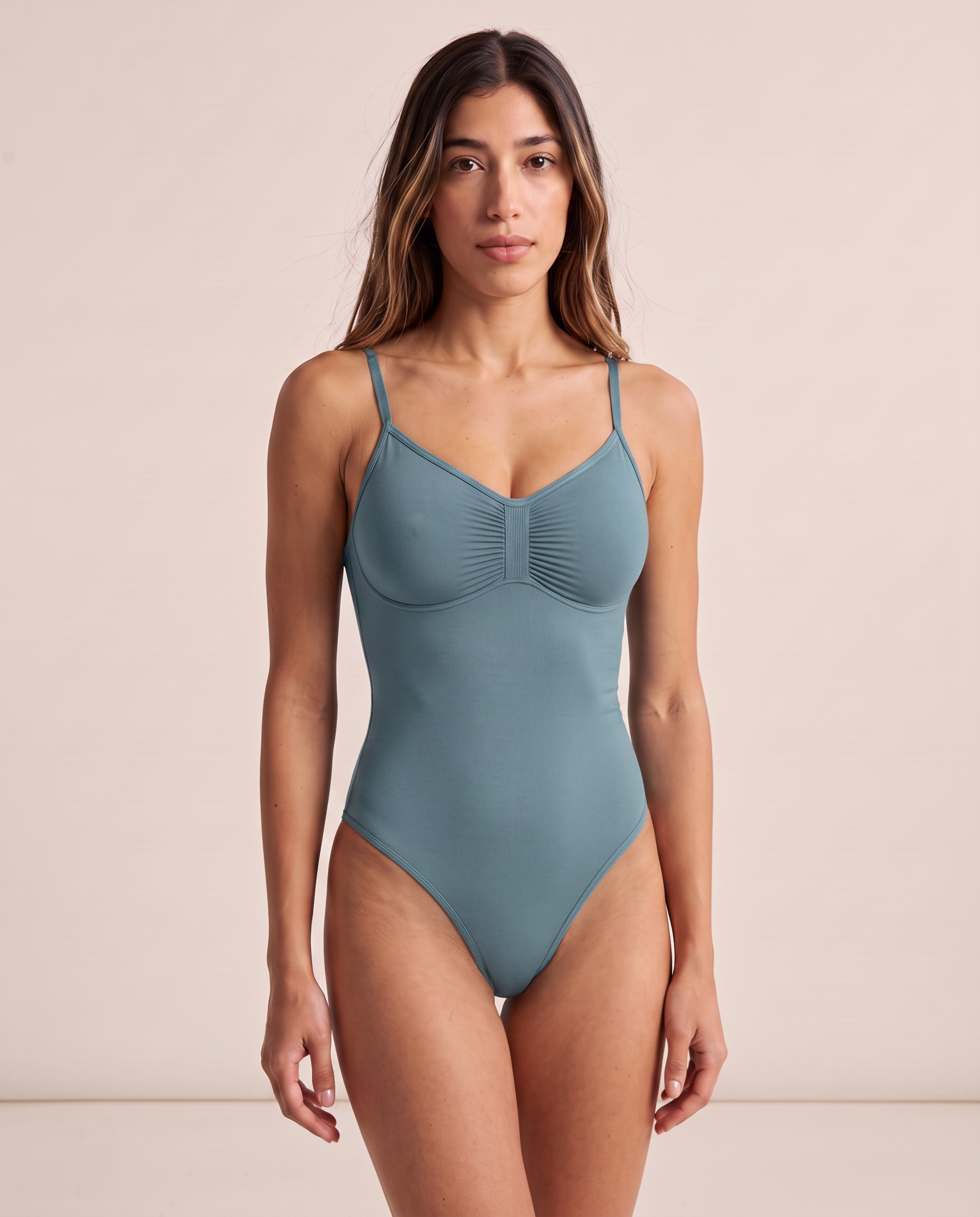 Model wearing the full coverage One & Done Shaping Bodysuit in dusty teal blue