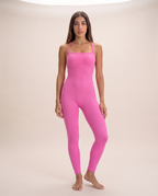 Model standing in a contrapposto pose wearing the Bra-Free Shaping Jumpsuit in Blush Pink, full length from shoulder to ankle.