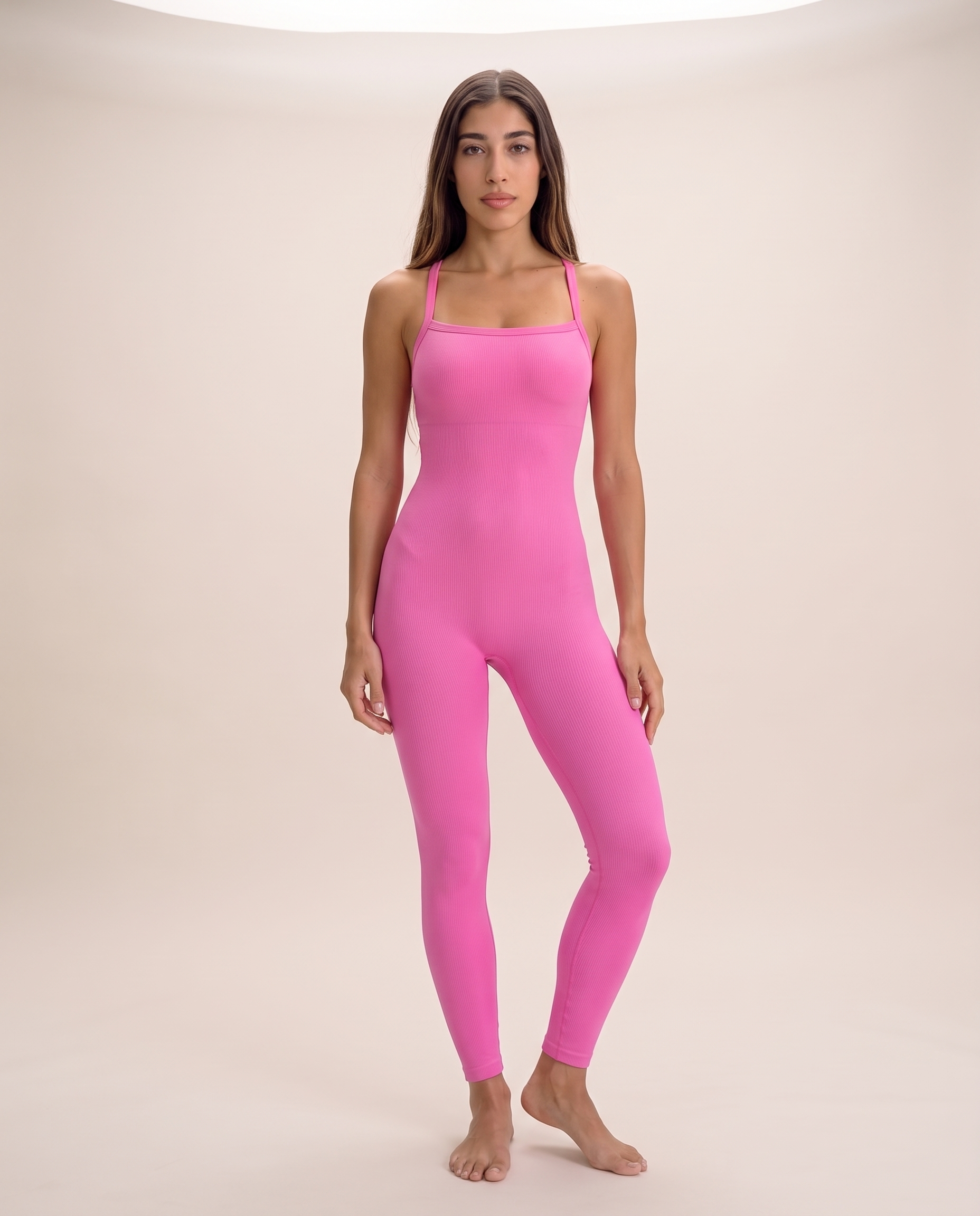 Model standing in a contrapposto pose wearing the Bra-Free Shaping Jumpsuit in Blush Pink, full length from shoulder to ankle.