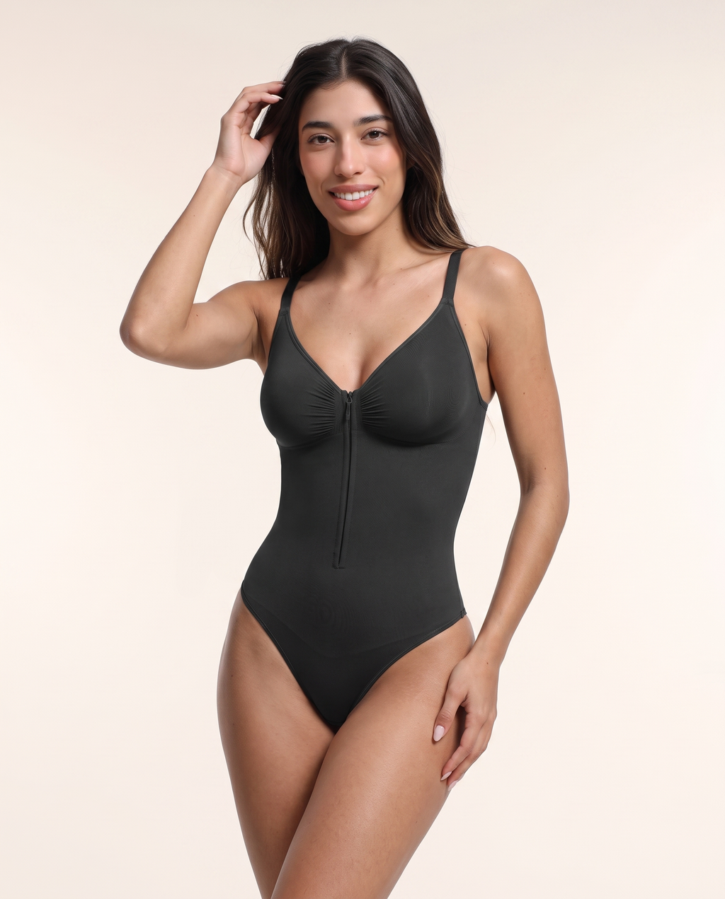 Front three-quarter view of the Plunge Chest-Support Bodysuit in Black, fully zipped.