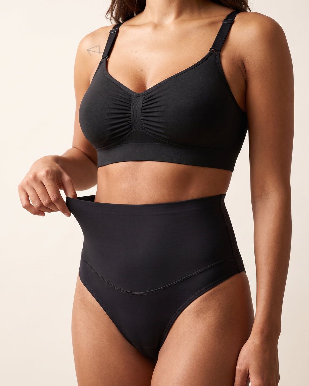 No-Show Tummy Control Thong in Black — three-quarter view showing the stretch fit.