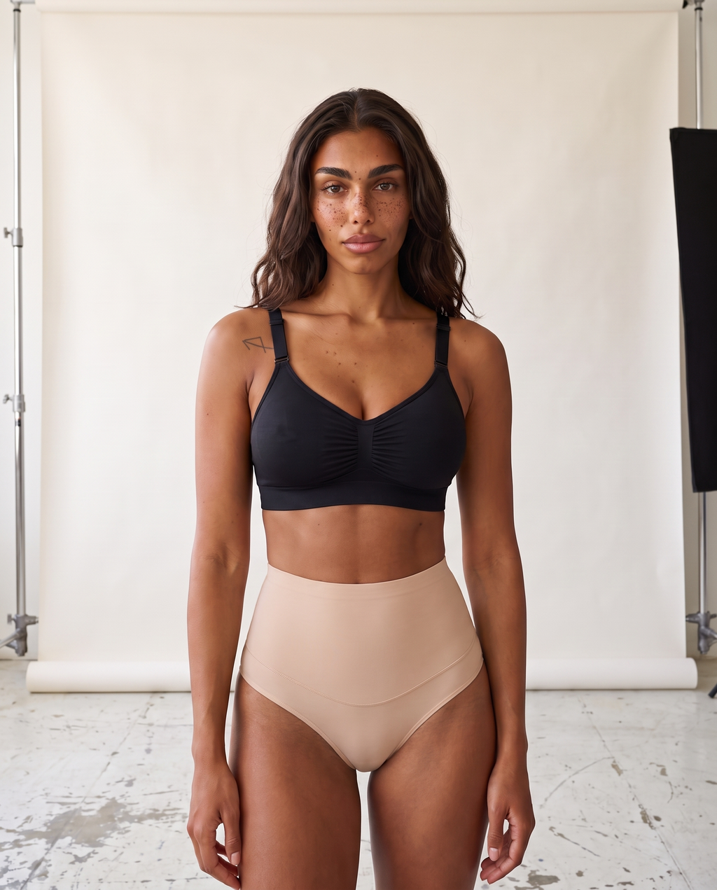 No-Show Tummy Control Thong in Light Nude — front product view in studio.