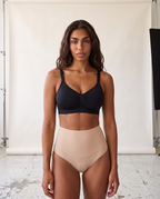 No-Show Tummy Control Thong in Light Nude — front product view in studio.