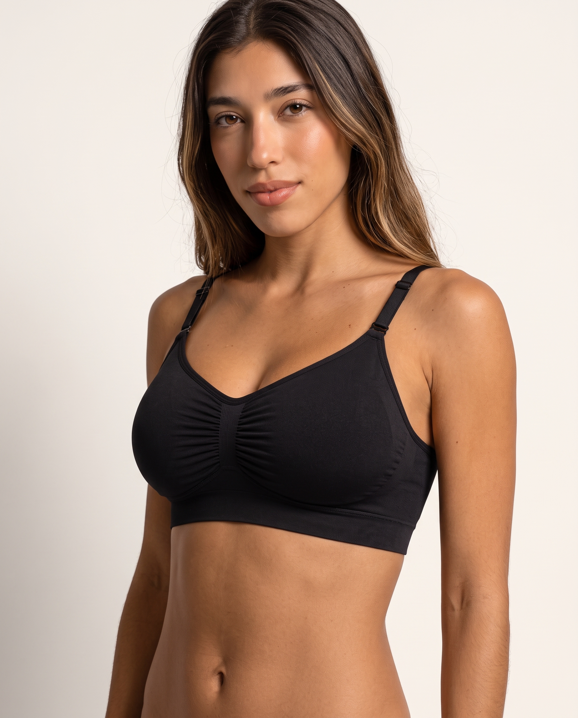 Model wearing the Wireless Shaping Bra in black, three-quarter view
