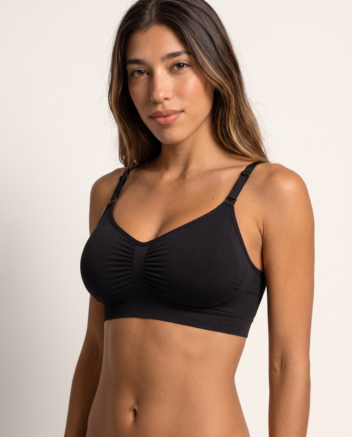 Model wearing the Everyday Wireless Bra in black, three-quarter view