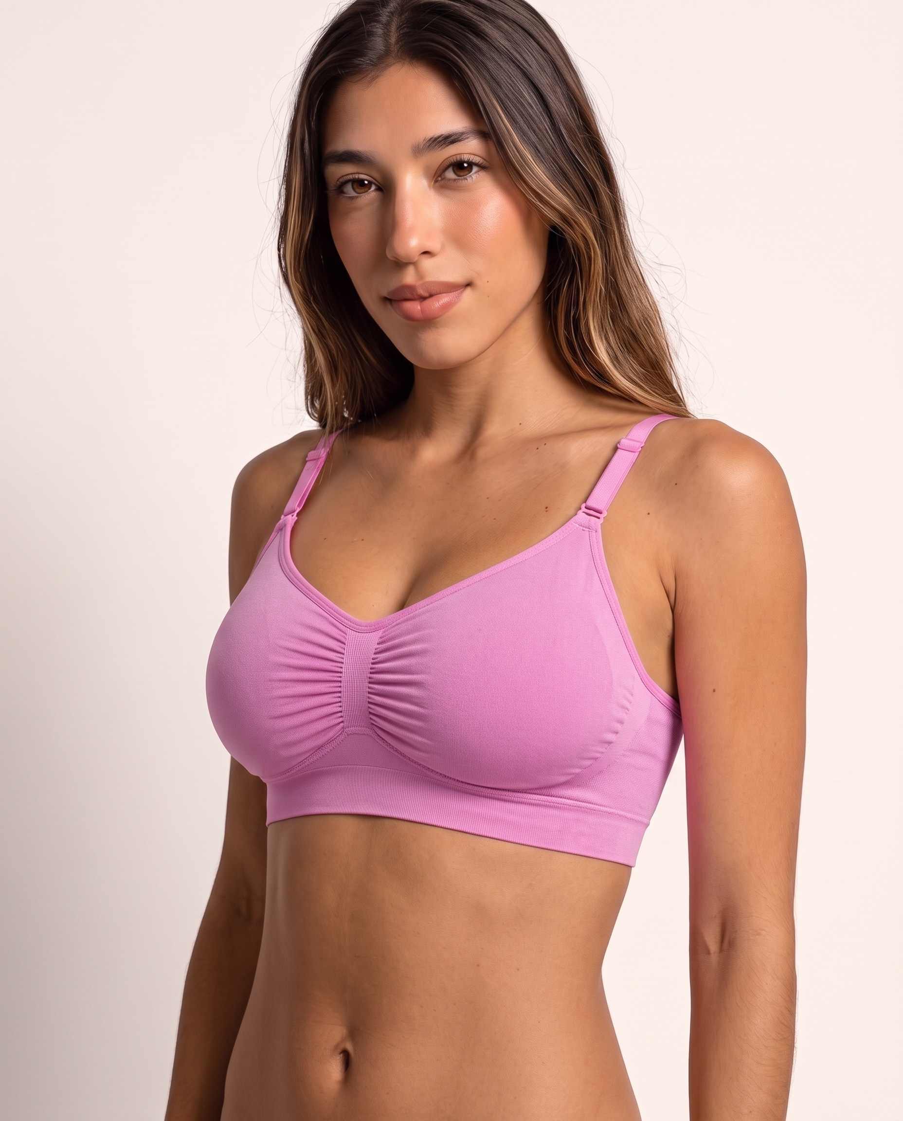 Model wearing the Wireless Shaping Bra in candy pink, three-quarter view