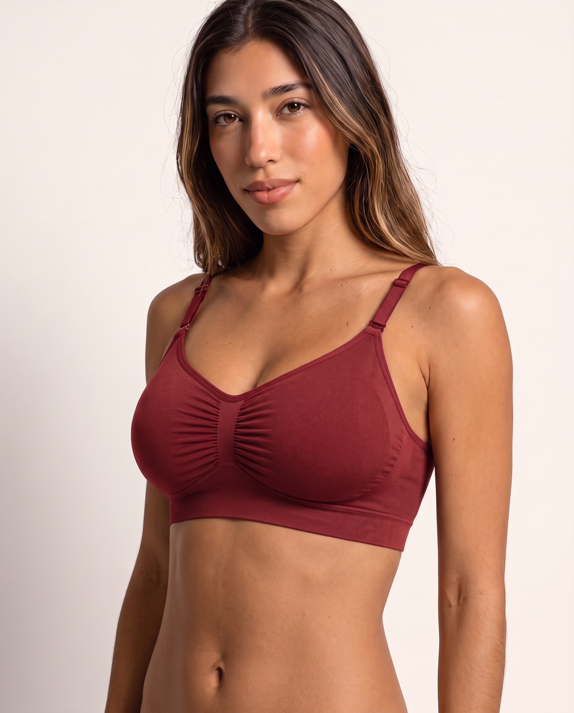 Model wearing the Wireless Shaping Bra in dark red, three-quarter view